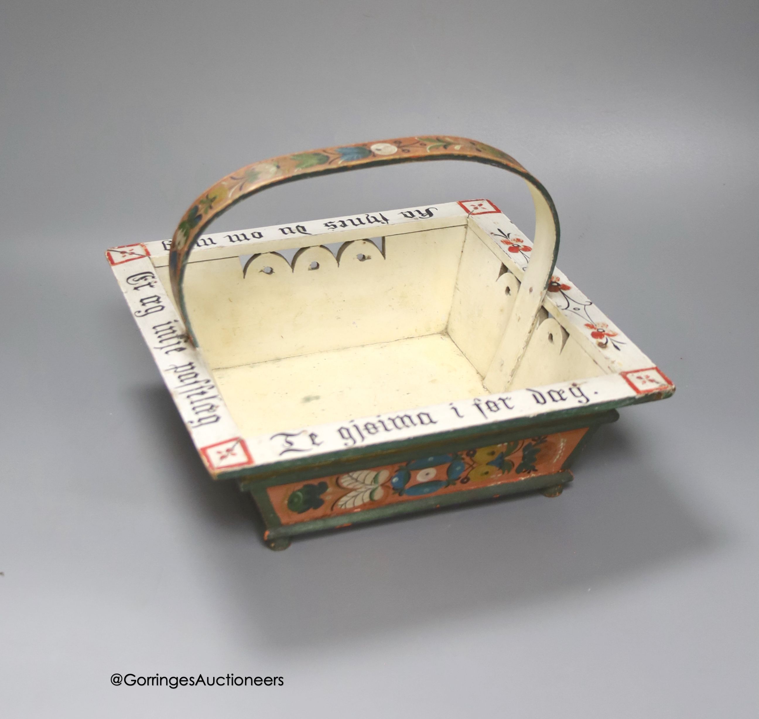 A Norwegian wood basket, painted with script and flowers in polychrome, 25cm